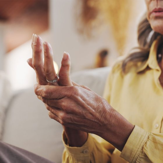 Older adult holding a painful hand, MAT for chronic pain and arthritis in Midland, TX